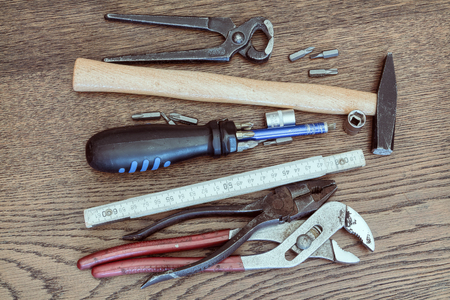 Tools on a wooden table representing a maintenance repair kit.