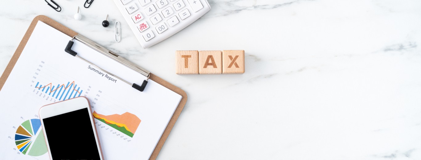 Concept of calculating and paying tax with smart phone on white table.
